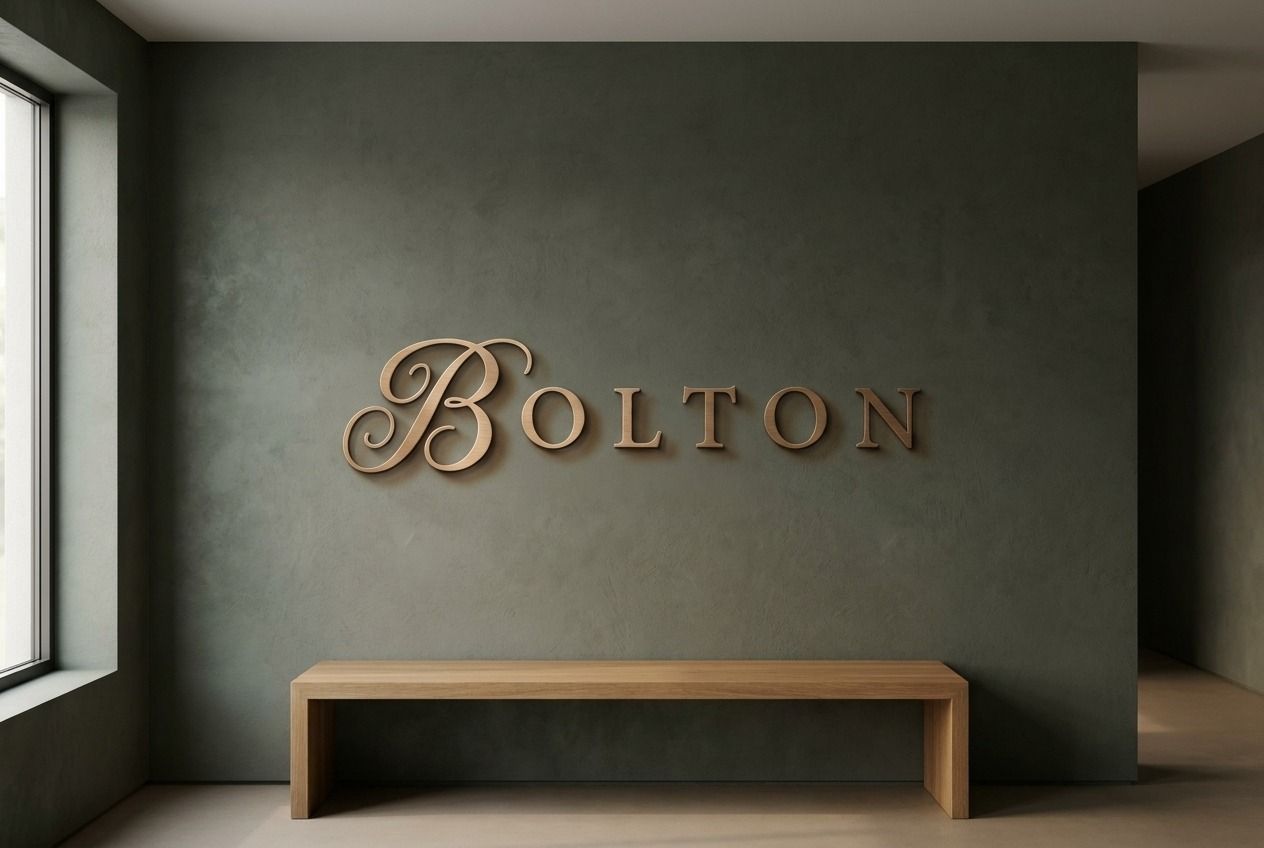 The Bolton wordmark in metal on a moss lobby wall