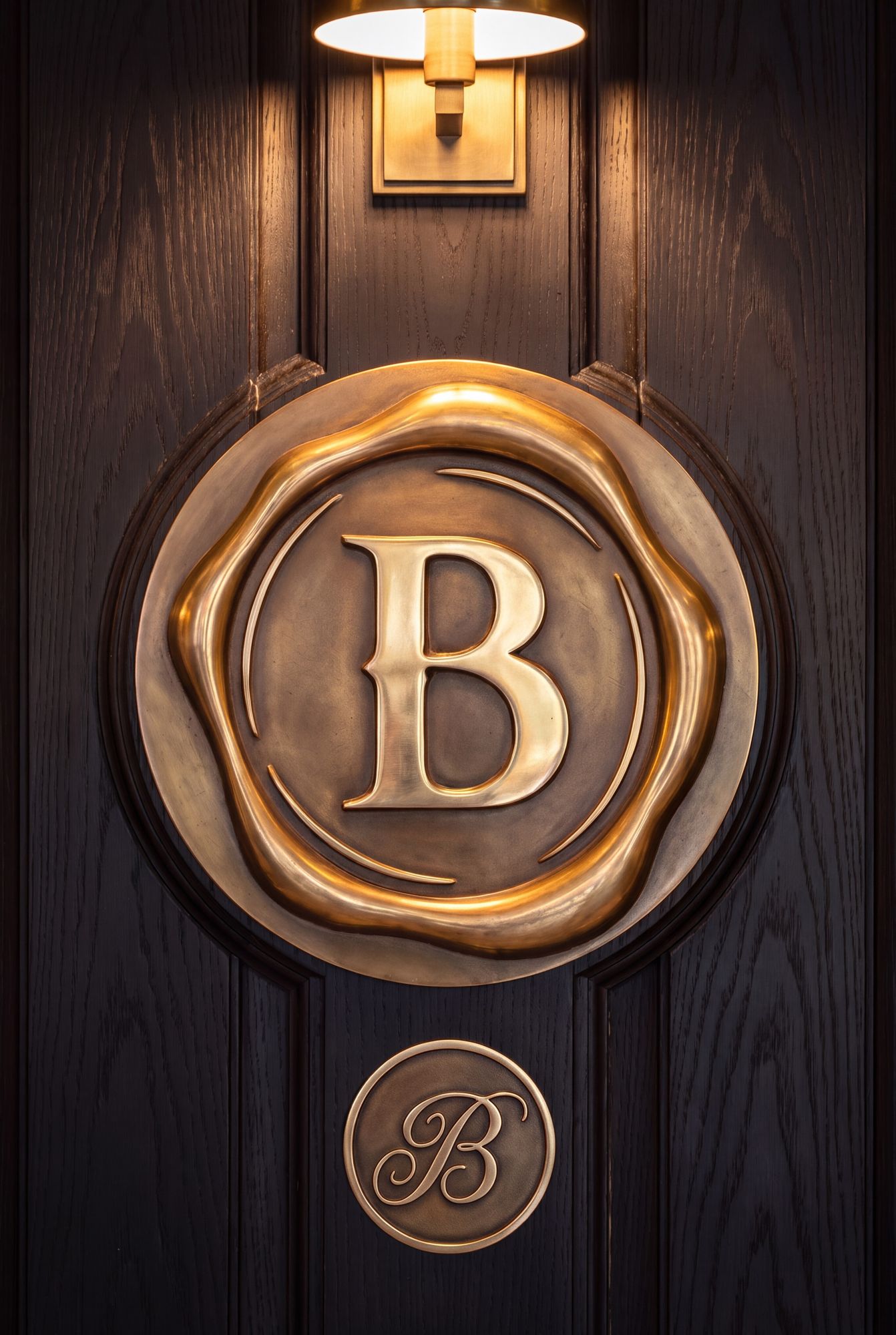 A bronze Bolton seal on a dark door